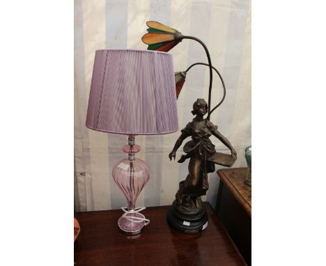A SPELTER TABLE LAMP with a figure of commerce and two glass shades above 70.1cm high overall together with a purple glass ta