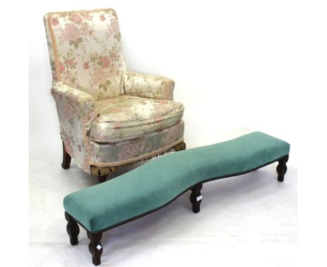 AN EARLY 20TH CENTURY MAHOGANY FRAMED LONG LOW UPHOLSTERED STOOL, 137cm in length together with an armchair, the front legs w