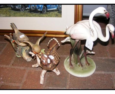 A Goebel model of bird feeding, together with two others 