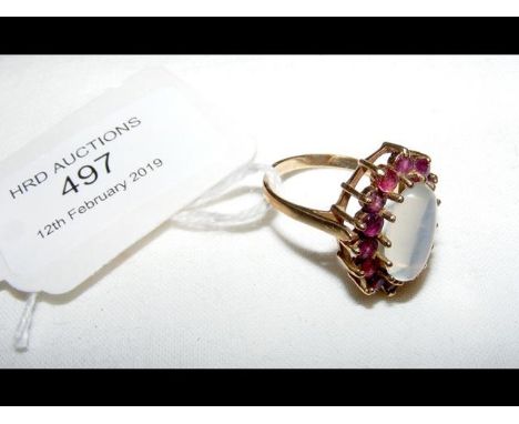 A gold moonstone and ruby ring 