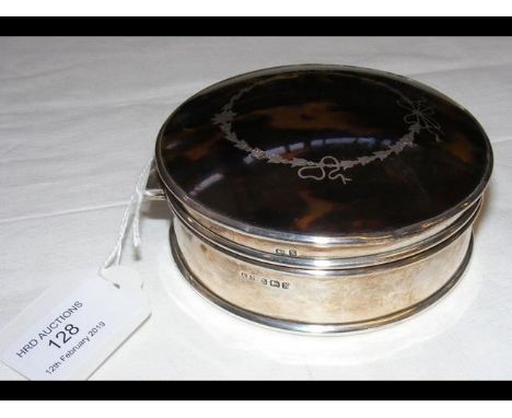 A 10.5cm diameter silver trinket box with silver inlay to the domed lid 