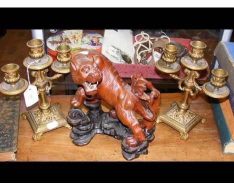 A pair of decorative candelabra, together with a carved wooden Tiger 