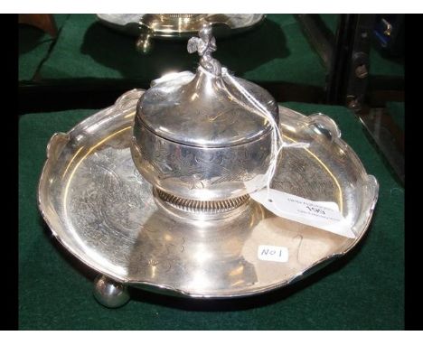 A silver Victorian inkwell with cherub to the top 