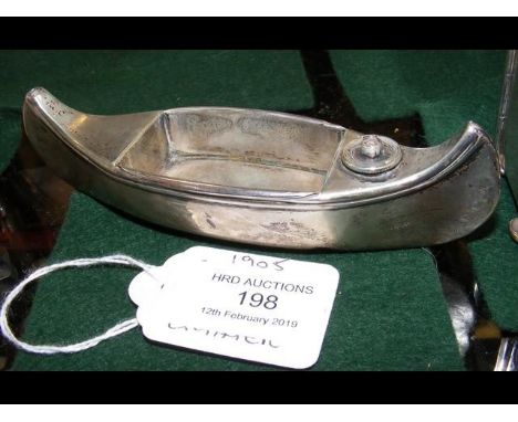 A silver cigar lighter in the form of a canoe by Stokes &amp; Ireland - 1905 - 13cm long CONDITION REPORTfew dinks as per ima