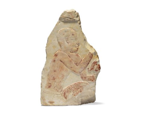 An Egyptian polychrome painted limestone relief section,Late Period, circa 664-525 B.C.,with a squatting male facing right, t