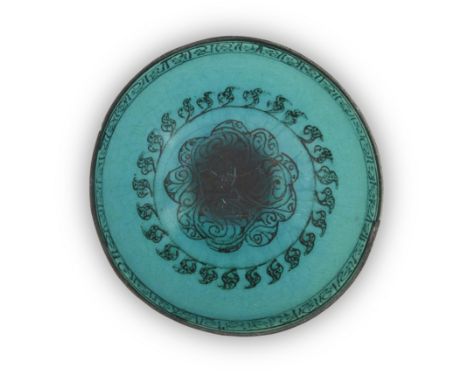 To Be Sold With No ReserveAn intact Raqqa ware black slip turquoise glazed bowl,Syria, first half 13th century,On short conic