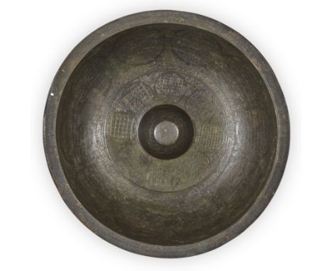 An engraved copper alloy magic bowl,Qajar Iran, dated AH 1221/1806 ADOf typical form, on short straight foot, the well with r