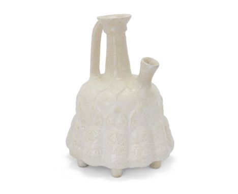 To Be Sold With No ReserveA white-glazed moulded pottery flaskGurgan, Iran, 12th-13th centuryOn six feet, with plain base, ea
