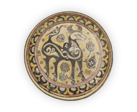 A yellow, green, black and ochre pottery dish,Eastern Iran or Transoxiana, 10th century or later,With an ox amidst floral spr