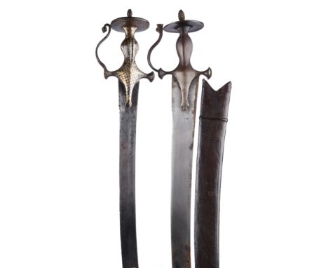 Two Indian swords (tulwar), each with characteristic steel hilt having short button terminal quillons and disc pommels: the f