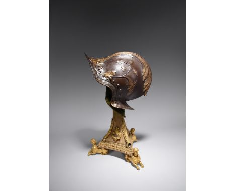A very fine embossed steel burgonet in the 16th century North Italian style, the peak surmounted by a monstrous leaf mask, vi
