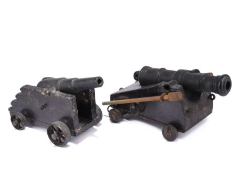 Two 19th century model cannon, naval types on wooden carriages with small wheels, one being of ring turned form and the other
