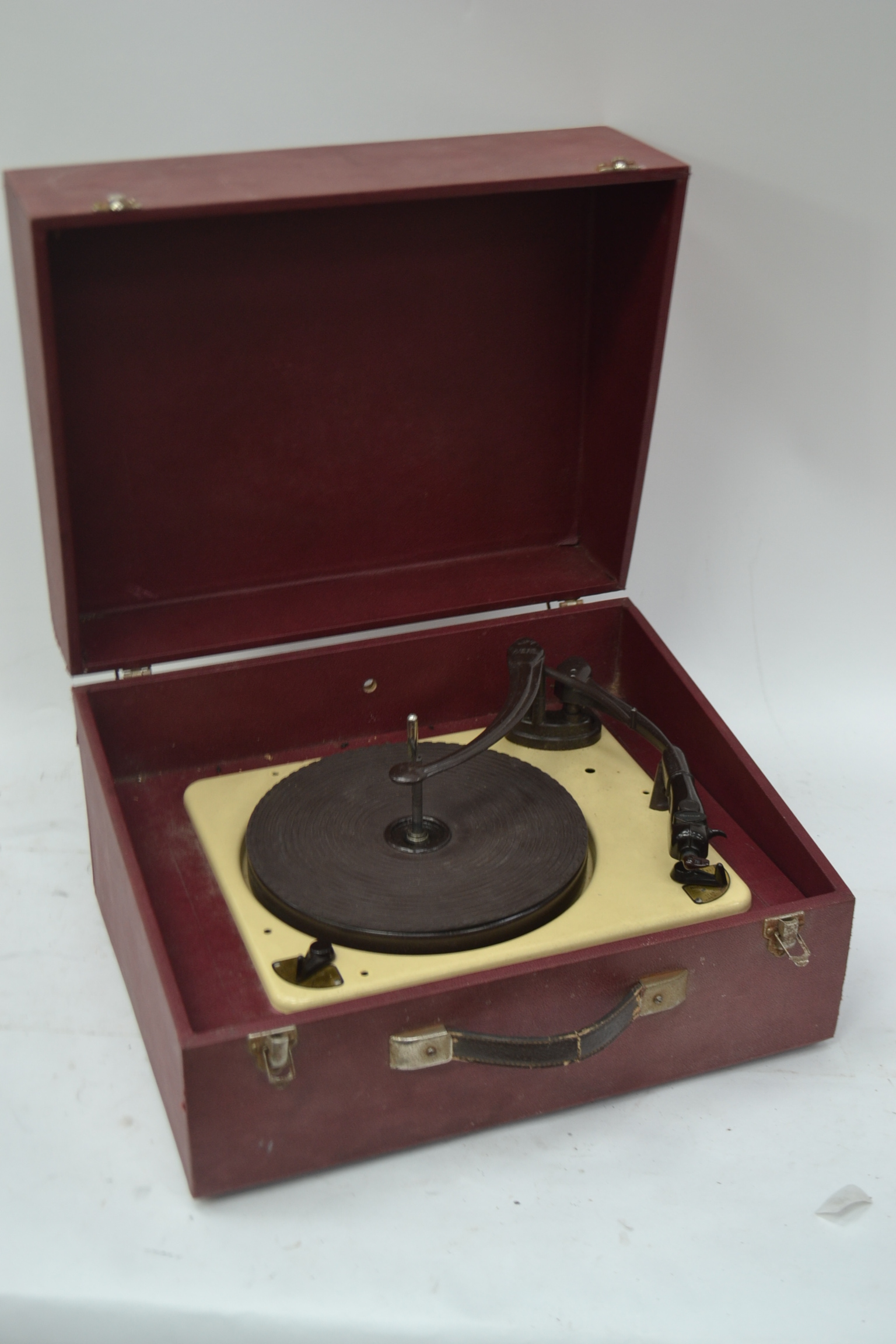 A cased vintage 1940's 1950's portable record player in claret