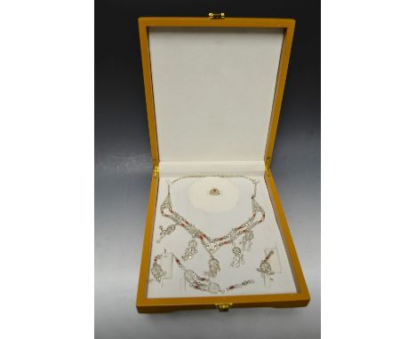 An Indian White metal and coral bead bridal suite, comprising an fringe necklace, pair of earrings, bracelet and ring, unmark