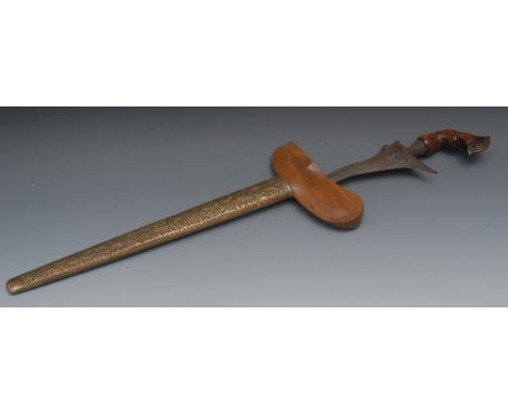 An Indonesian kris, 35cm wavy blade, hardwood handle carved with stylised leaves, chased brass scabbard, 50cm long overall, e