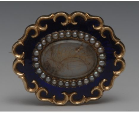 An early 19th century yellow gold shaped oval mourning brooch the centre with hair sample surrounded by seed pearls, blue ena