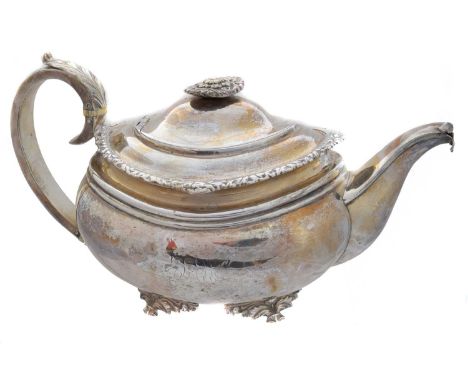 A George IV silver teapot, of squat form, with foliate border, acanthus leaf handle with ivory insulators and raised on four 