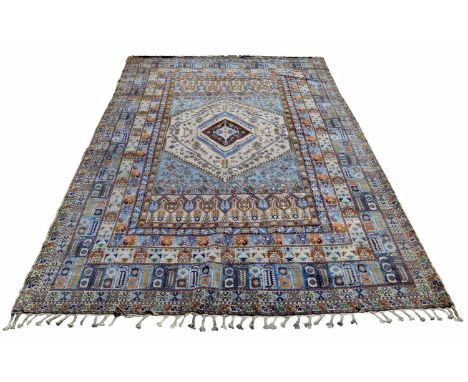 Modern wool and cotton rug of caucasian design, multi banded border to central medallion predominantly in blues and ivory.370