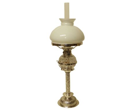 Late Victorian silver plated candle lamp of cylindrical form with chased rococo foliate decoration, on a similarly decorated 