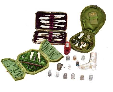 A selection of sewing items, to include cased sewing kits, EPNS pin cushion and silver thimbles, one stamped 14k.