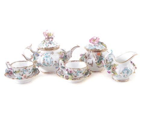 English porcelain miniature tea service, encrusted with flowers comprising of a teapot, sucrier, jug, two cups and saucers.  