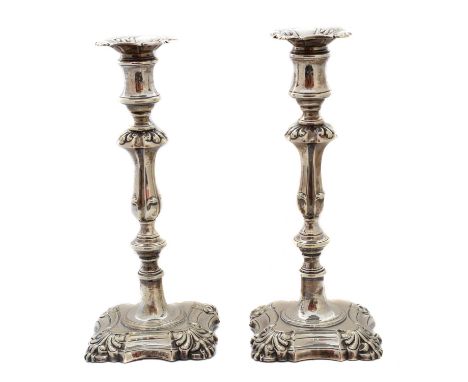 A pair of Victorian silver candlesticks, each designed as a knopped and slightly tapering stem with square spreading foot, ha