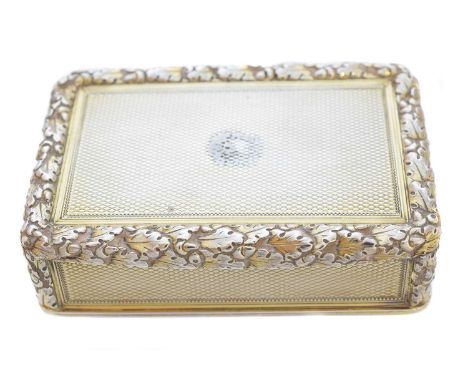 A George III silver gilt snuff box, of rectangular form with engine turned decoration, foliate border and silver gilt interio