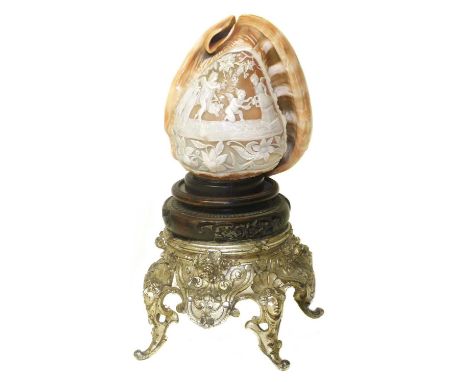 Table lamp, shade made from a carved Cameo shell depicting bacchanalian cherubs picking grapes and taking wine from amphora, 