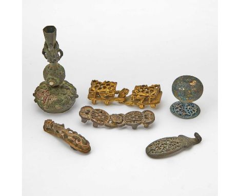 Comprising a gilt bronze chilong buckle, a 'fu' belt buckle, a stylized chilong belt hook, a parcel gilt dragon belt hook, a 