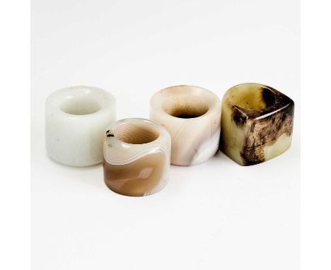 Comprising two jade rings and two agate rings.(Width of largest 1 1/2 inches)No condition report? Click below to request one.