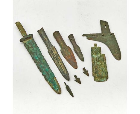 Comprising an axe, a dagger, a dagger-axe, three arrow heads, and three spearheads.(Length of dagger 12 1/4 inches)No conditi