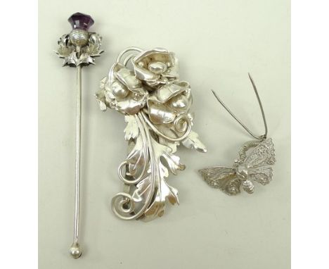 A silver clip cast as a scrolling floral spray, 1.03toz, silver filigree trembleuse butterfly pin, and a silver thistle twizz