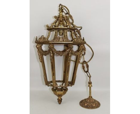 A late 20th century brass lantern ceiling light, decorated with acanthus leaves and floral garland swags and tails, 26 by 26 
