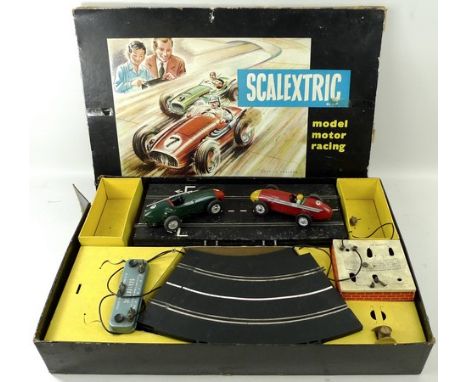 A Scalextric model racing boxed set, with a Maserati and Ferrari, lacking one driver, including track and control unit.