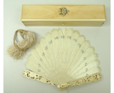 A European ivory stick fan, late 19th century, the guards carved with birds and flowers, with silk tassle, in an ivory box, m