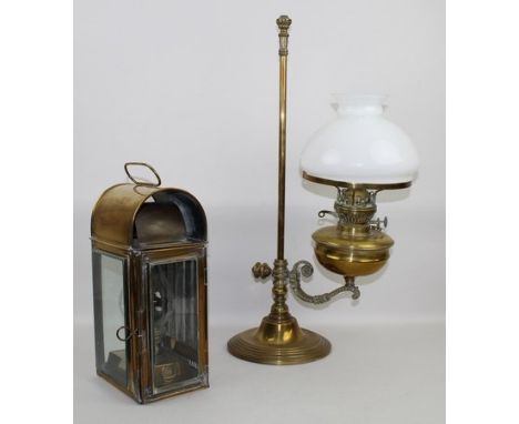 A Victorian brass lantern with bevelled glass panels and door, the oil burner having a glass shade, together with an Edwardia