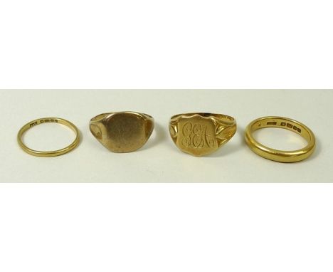 A group of four gold rings, comprising two 22ct gold wedding bands, size K and size I, 6.4g total, an 18ct gold signet ring, 