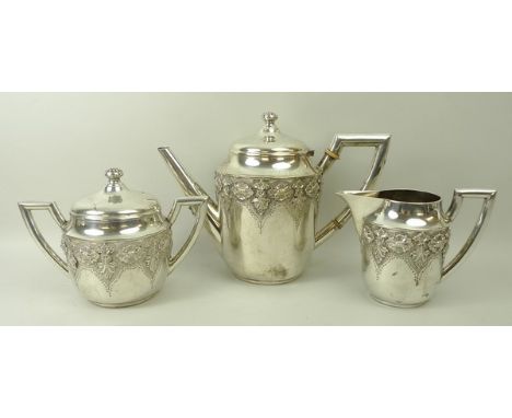 A Portuguese white metal three piece coffee set embossed with a band of acanthus leaves and flowers,, comprising coffee pot, 