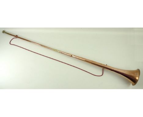 An early 20th century copper and brass hunting horn, 127cm long. 