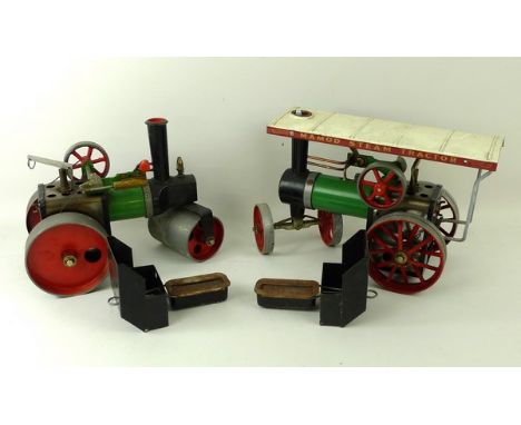 A Mamod steam tractor with green livery and white roof, and a Mamod steam roller.