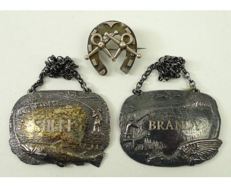 A pair of cast silver decanter labels decorated with fishing and hunting scenes, for Sherry and Brandy, London 1975, 2.105toz