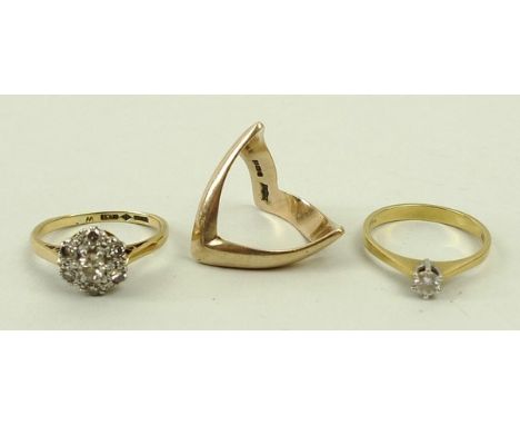 An 18ct gold solitaire diamond ring, size K, 1.9g, a 9ct gold and diamond cluster ring, size M, 3.2g, and a 9ct gold ring in 