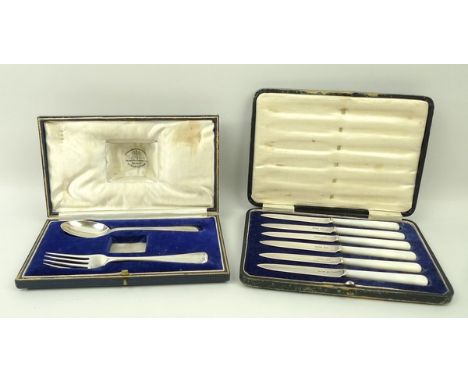 A set of six silver butter knives with mother of pearl handles, Sheffield 1918, boxed, together with a boxed christening set,