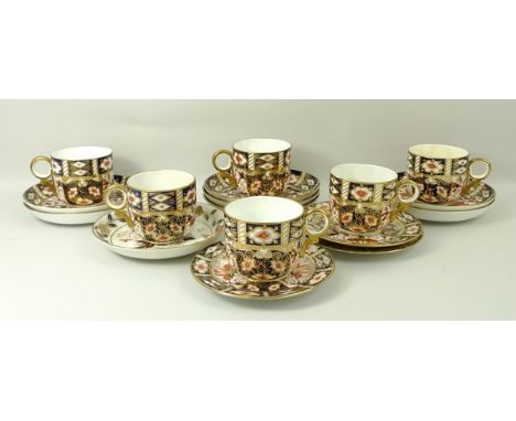 A group of Royal Crown Derby porcelain imari decorated pattern no 2451, comprising six tea cups and seven saucers, three dish