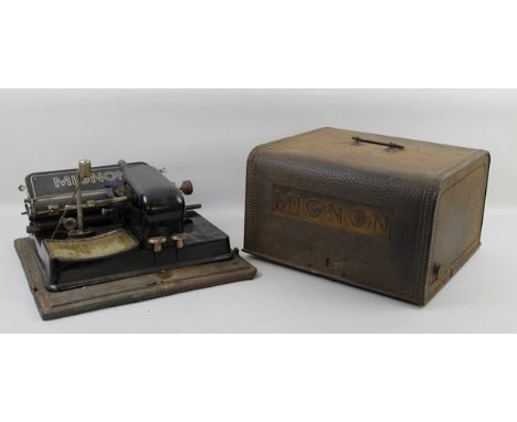 A Mignon typewriter stamped DRGM, in a planched tin plate carrying case, 33 by 31 by 20cm high.