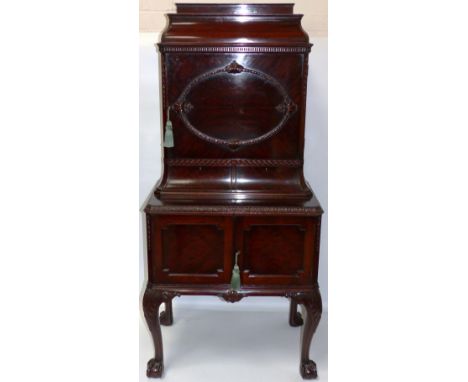 An early 20th century Georgian style mahogany side cabinet by Waring & Gillow, with carved decoration, cabriole legs and ball