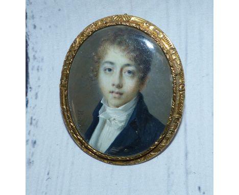 An early 19th century head and shoulders miniature portrait on ivory of an 18th century youth, signed 'Barrois', in chased gi