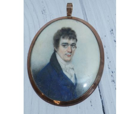 An early 19th century half-length miniature portrait on ivory of a young man, with memorial back having seed pearl mounted lo