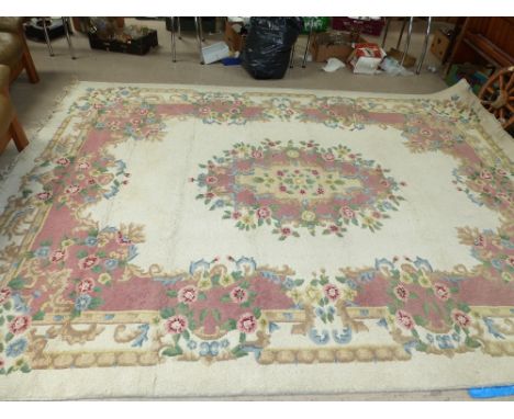 A large cream ground Chinese carpet with floral pattern