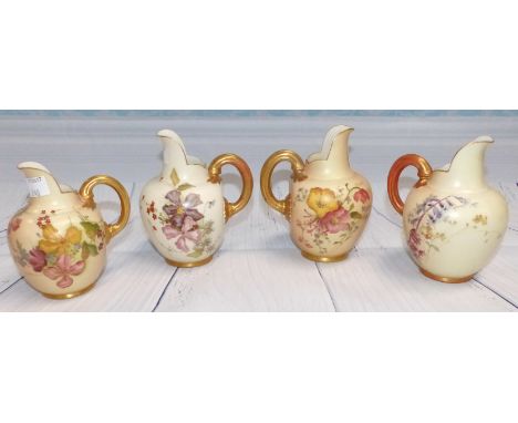 Four late 19th Century Royal Worcester porcelain jugs hand painted with floral decoration against a peach blush/ivory ground 